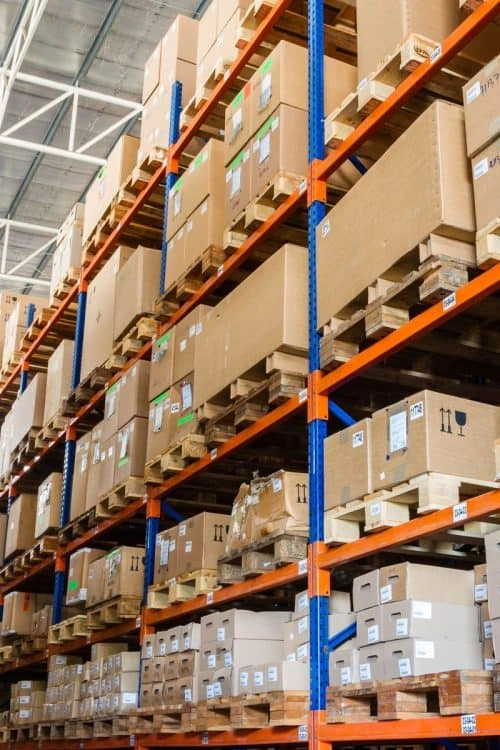 Warehouse pallet racking system with stacked cartons and packaged goods