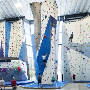 Commercial indoor climbing gym with multi-wall routes, auto belay systems, and climbers for FECs & adventure centers