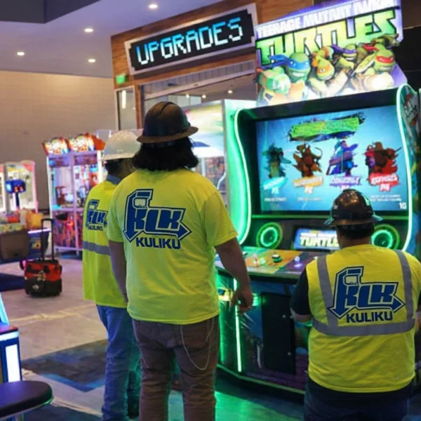 Kuliku technicians installing and testing arcade machines at an entertainment venue