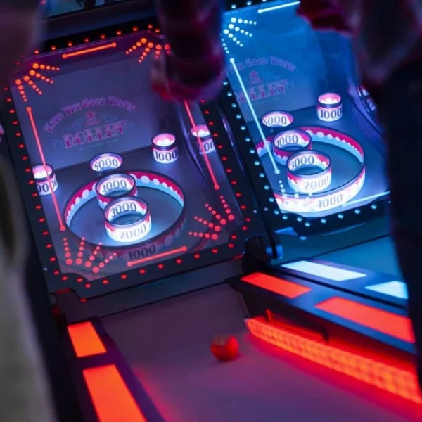 Classic Skee Ball arcade redemption game with glowing score rings and rolling ball in a vibrant Kuliku entertainment center